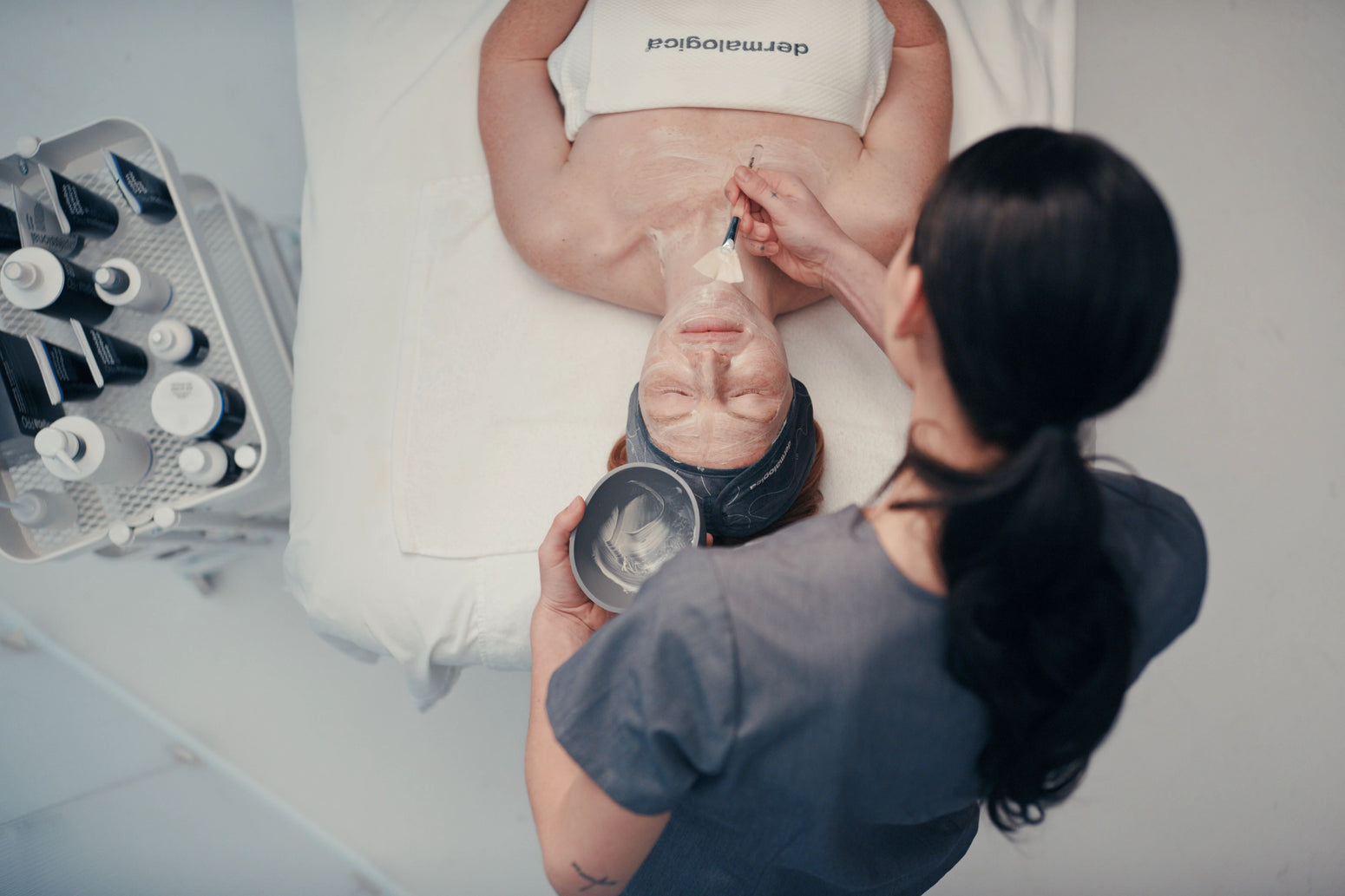 Skin therapist applies treatment to patient